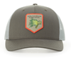 Grundens Bass Popper Trucker Hat with vibrant bass lure graphic and breathable mesh back.