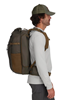 Side view of model wearing Simms Headwaters Backpack