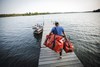 Large 200L rugged duffel with stable base and roll-up strap retainers, designed to prevent line catch and keep gear secure